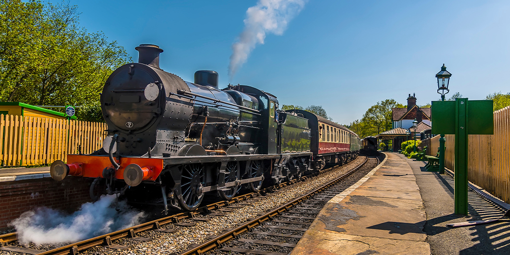 black locomotive with steam