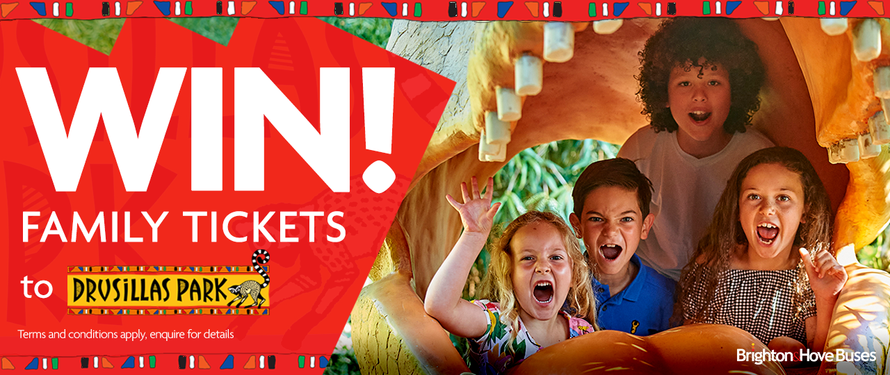 4 kids inside a plastic dinosaur's mouth with a graphic that says win family tickets to Drusillas Park