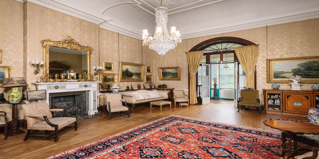 Image of Preston Manor from inside with a carpet, sofa and mirror in view