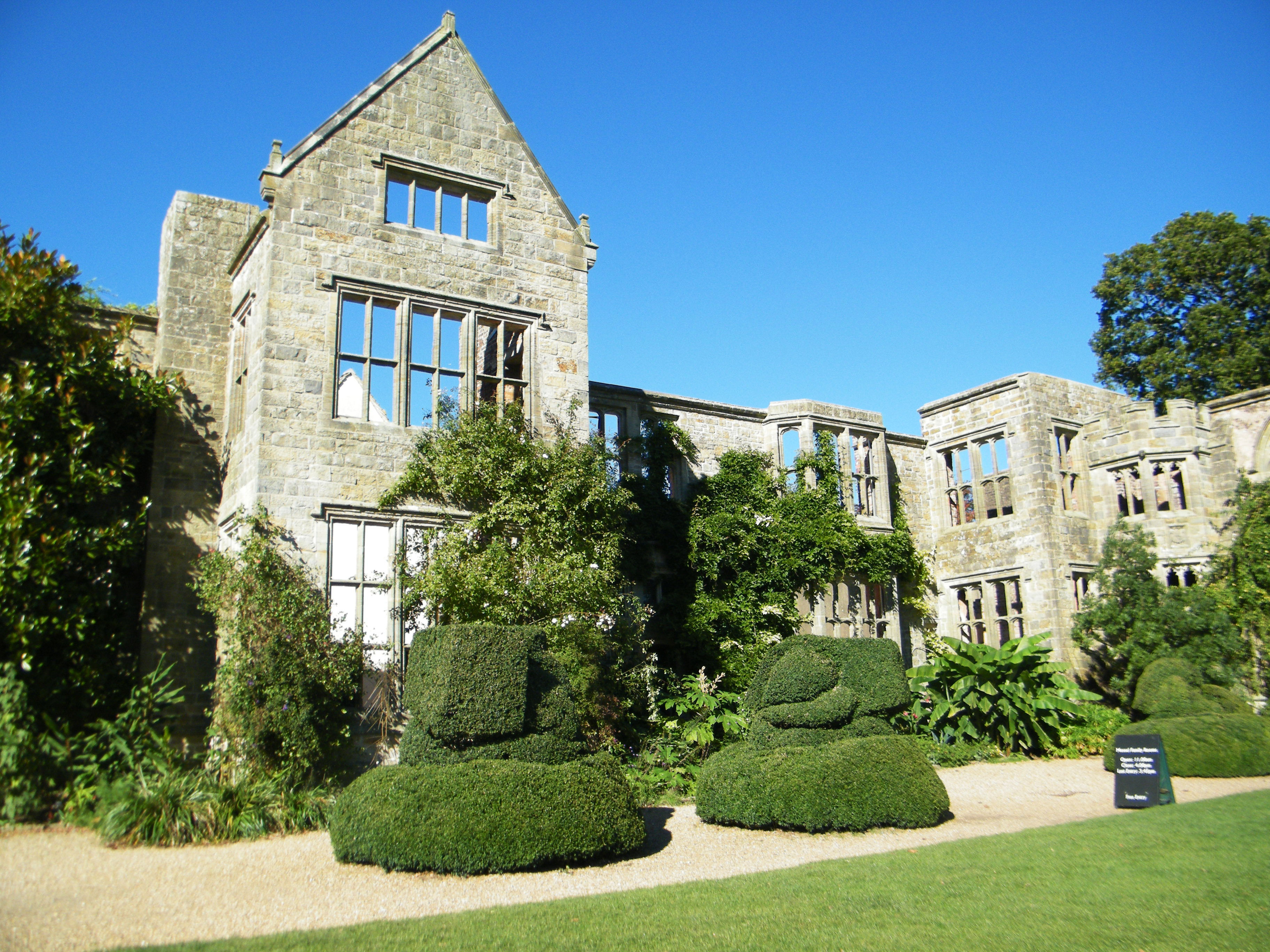 A large building next to hedges