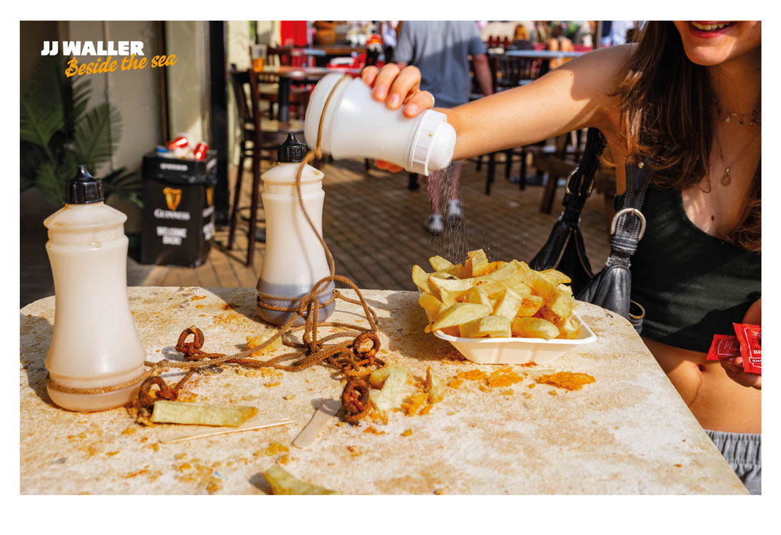 Shaking salt onto chips
