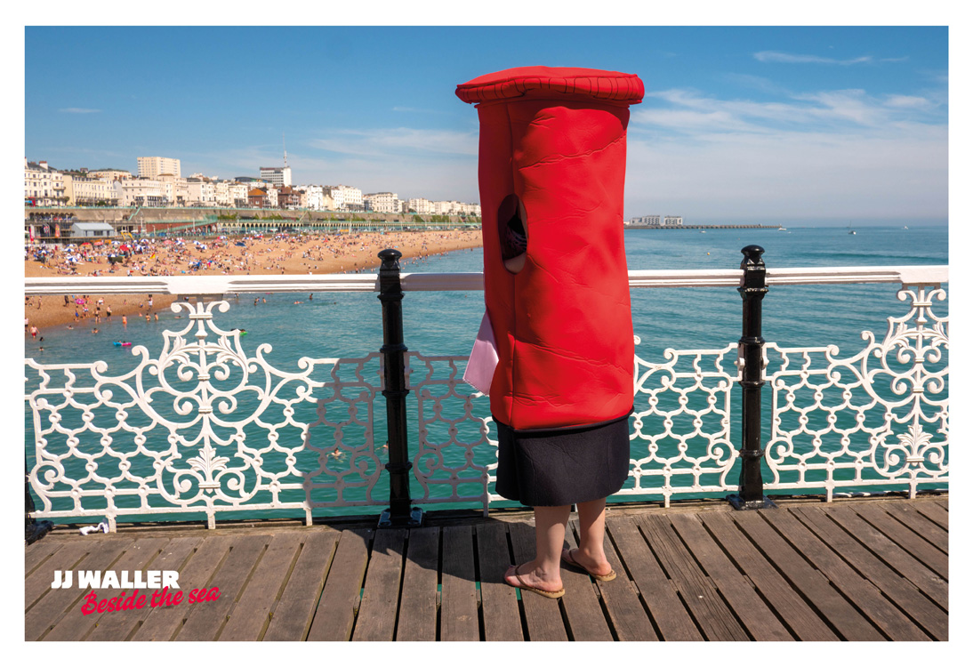 A person wearing a postbox xostume