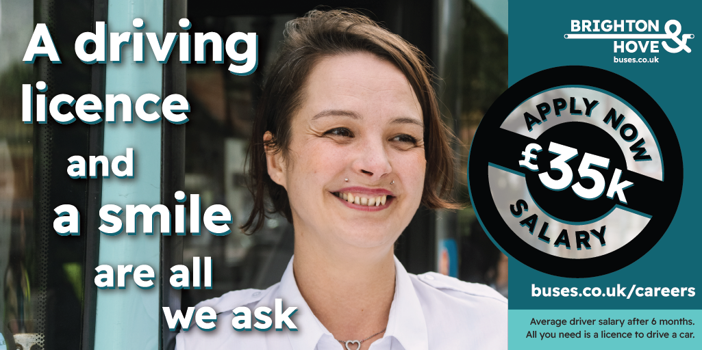 Bus driver smiling by the door of a bus with text saying 'A driving licence and a smile are all we ask'
