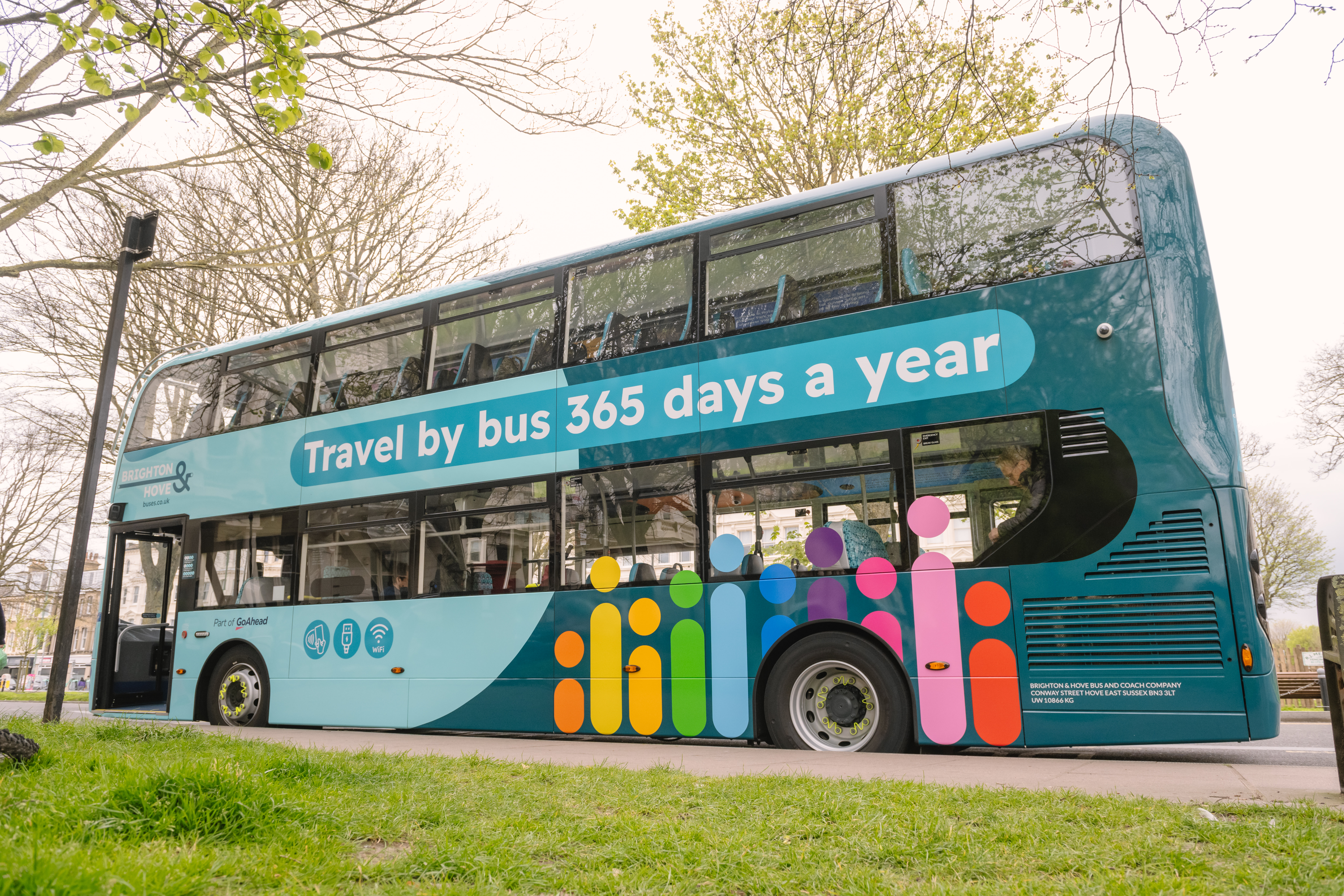 Image of the Brighton & Hove Buses new livery bus at a bus stop.