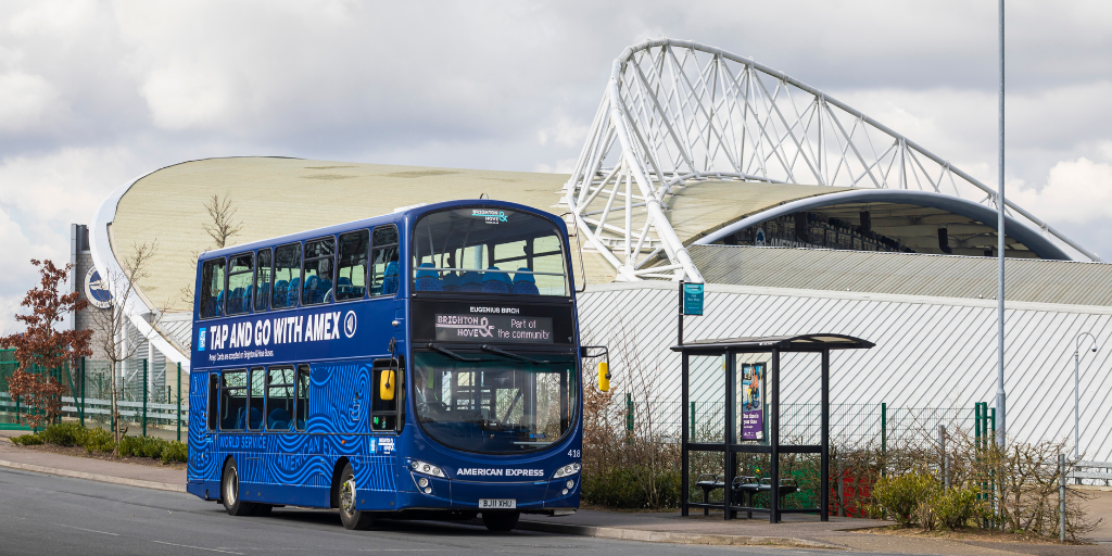 American Express wrapped bus in front of Amex football Stadium