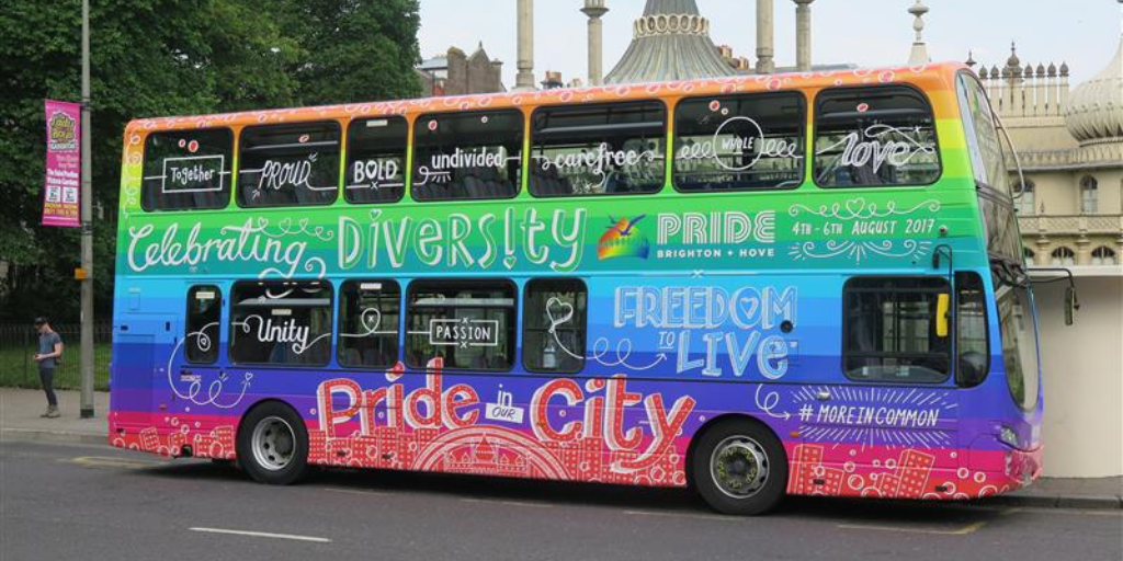 a bus parked up outside the pavilion featuring last year's pride design