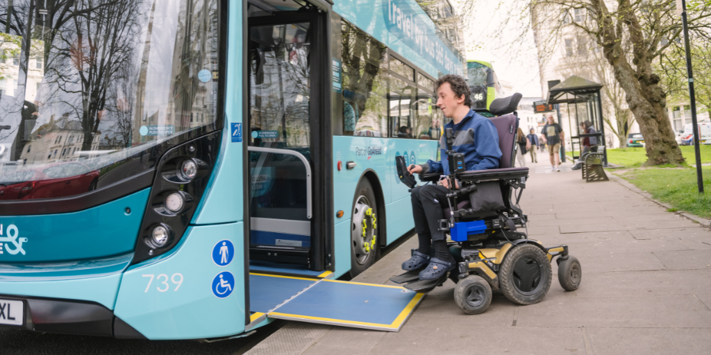 person in a wheelchair boarding a bus